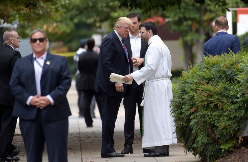 President Donald Trump talks with Rev. D. Andrew Olivo as he arrives to attend church at St. John’s Church in Washington, Sunday, Sept. 3, 2017. (AP Photo/Susan Walsh)